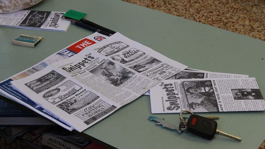 A newsletter sits on a coffee table.