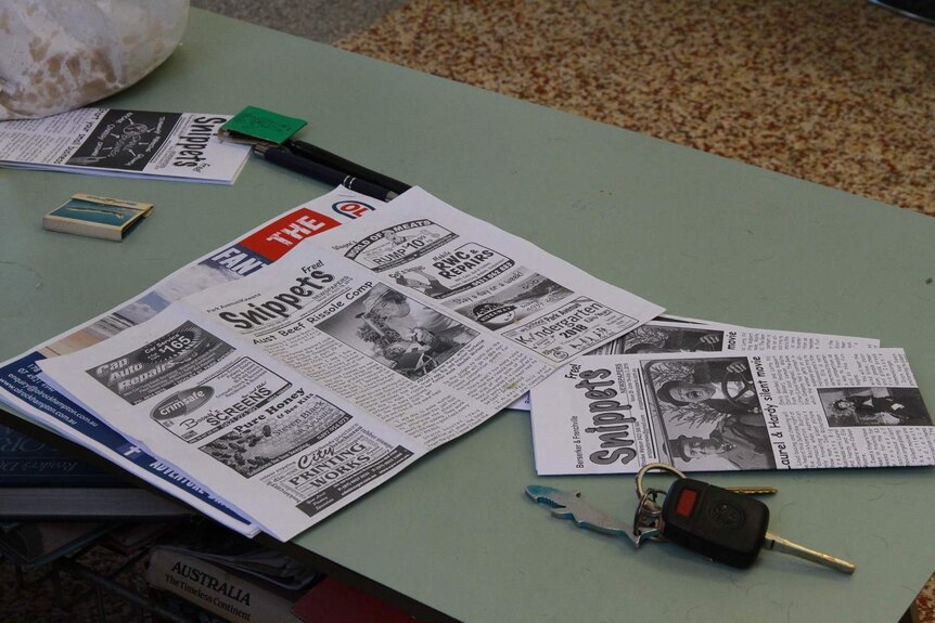 A newsletter sits on a coffee table.