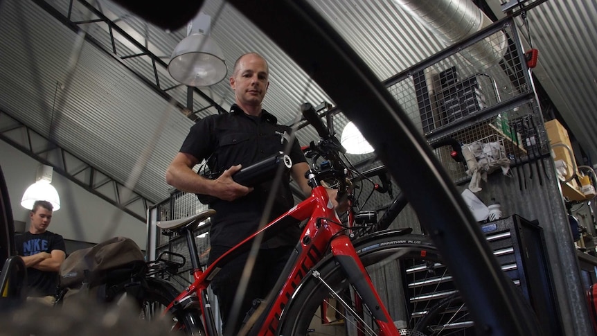 Trevor Rix poses with some of his bikes.