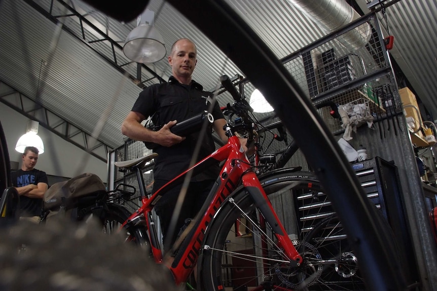 Trevor Rix poses with some of his bikes.