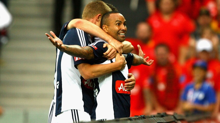 Archie Thompson celebrates against the Reds