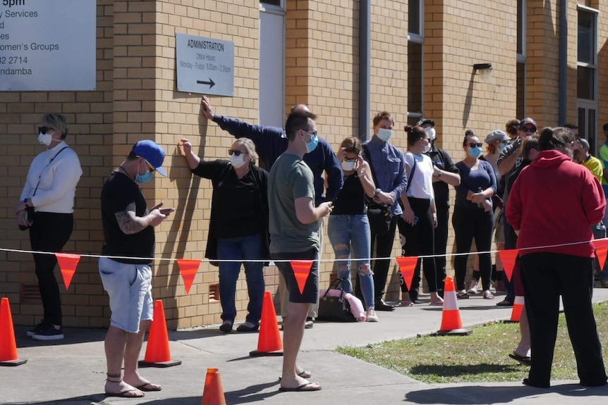 A long queue of people outside a building