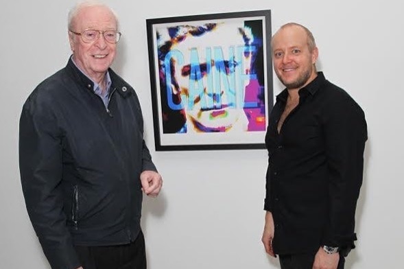 Actor Michael Caine and Artist Lincoln Townley stand in front of artwork of Mr Caine