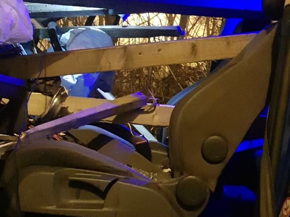 Wood pierces windscreen after crash in Leeds. There are about 5 planks piercing through the front of the car.