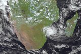 A satellite image shows a cyclone coming ashore over Mozambique.