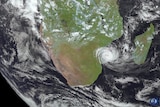 A satellite image shows a cyclone coming ashore over Mozambique.