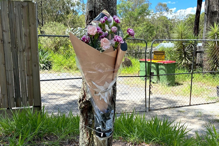 Flowers outside the property where a man was mauled to death by dogs