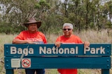 Aunty Sally Vea Vea, and Nhayla Nicky Hatfield standing behind Baga National Park sign in bush.