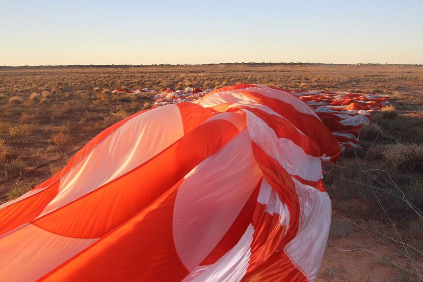 Massive deflated NASA scientific balloon on ground near Thargomindah in south-west Queensland