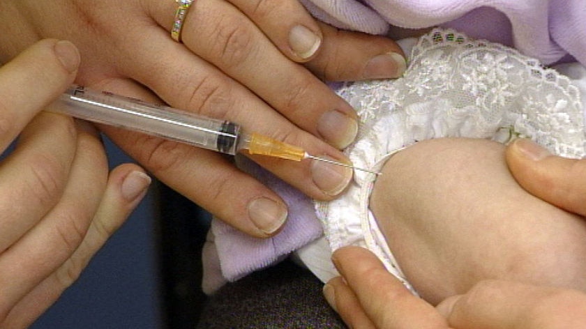 A close-up shot of a child's arm during a vaccination.