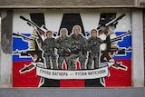 A mural with soldiers, guns and the Russian flag.