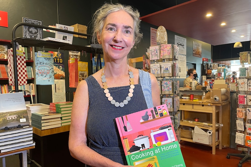 Fiona Stager, co-owner of Avid Reader bookstore, holds a book in her shop in Brisbane