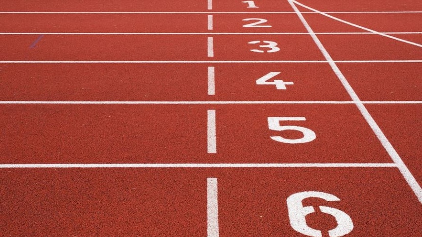 Picture of red running track with the numbers 1 to 6 marked along white lines 