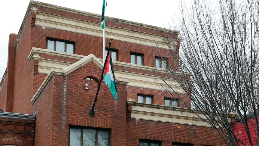 A flag flies at the front of Washington office of the Palestine Liberation Organization