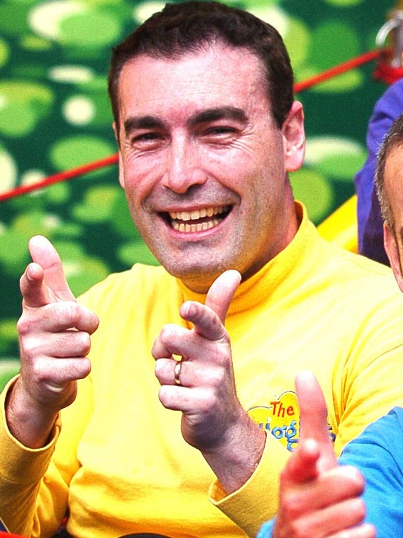 Yellow Wiggle, Greg Page, performs with the other Wiggles.