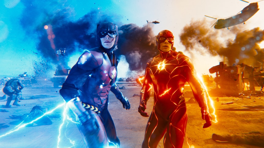 Two men dressed in superhero spandex costumes - one red, one blue - stand electrified and ready to fight.