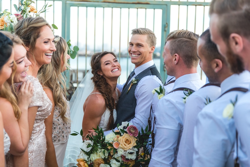 Sam and Alise stand with their wedding party