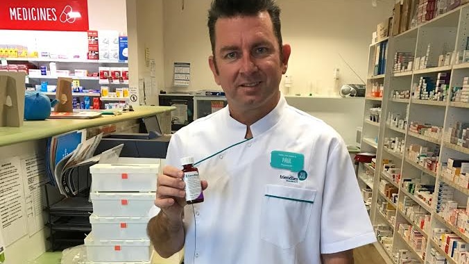 Pharmacist Paul Mavor with a bottle of the first commercial medicinal cannabis shipment