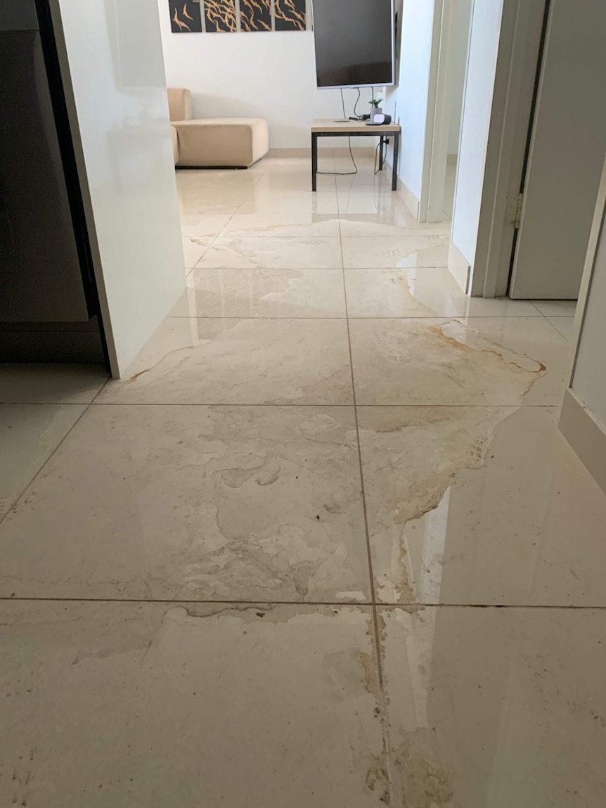 Water leaking on the floor of a Darwin apartment.