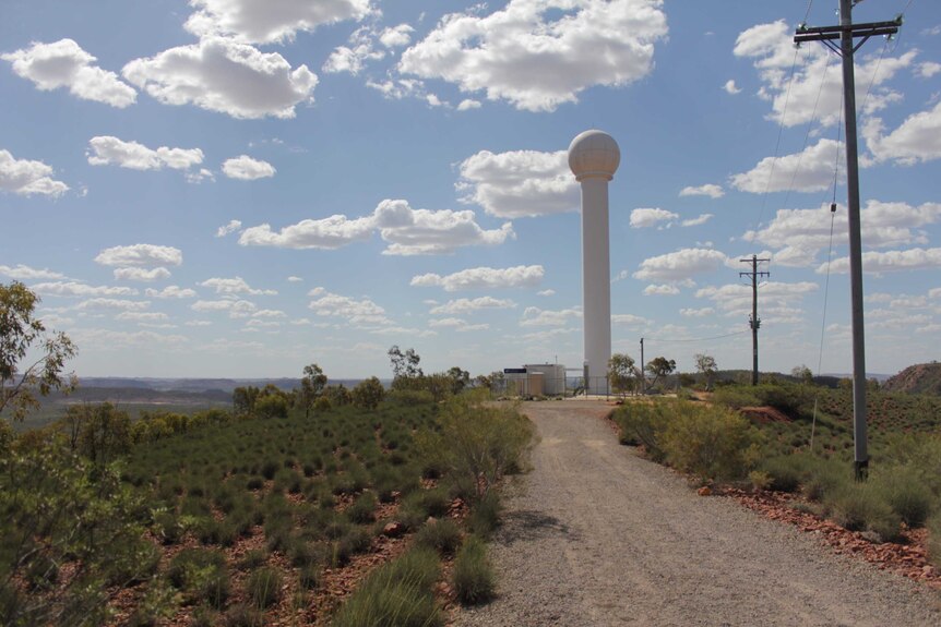 A tower with a ball shape on the end for a radar looking for rain