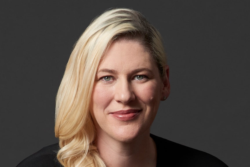 A headshot of Lauren Jackson in front of a black wall.