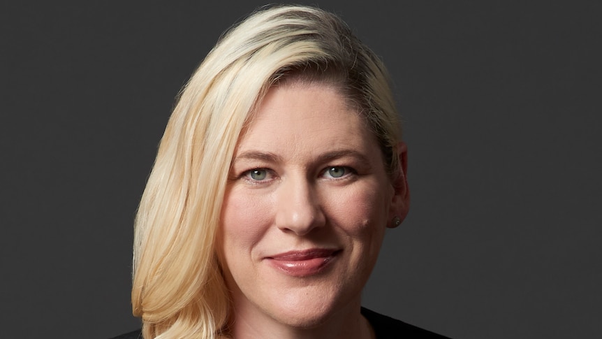 A headshot of Lauren Jackson in front of a black wall.