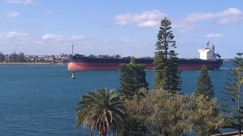 A large coal ship entering Newcastle harbour