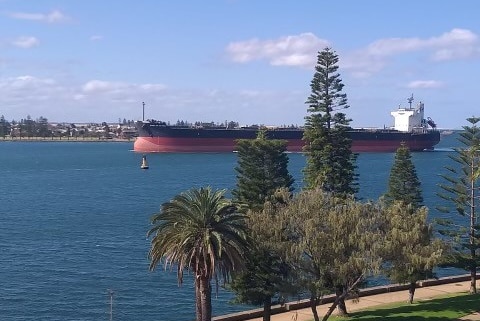 A large coal ship entering Newcastle harbour