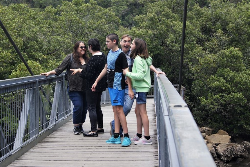 A family of for on a steel bridge in a national park