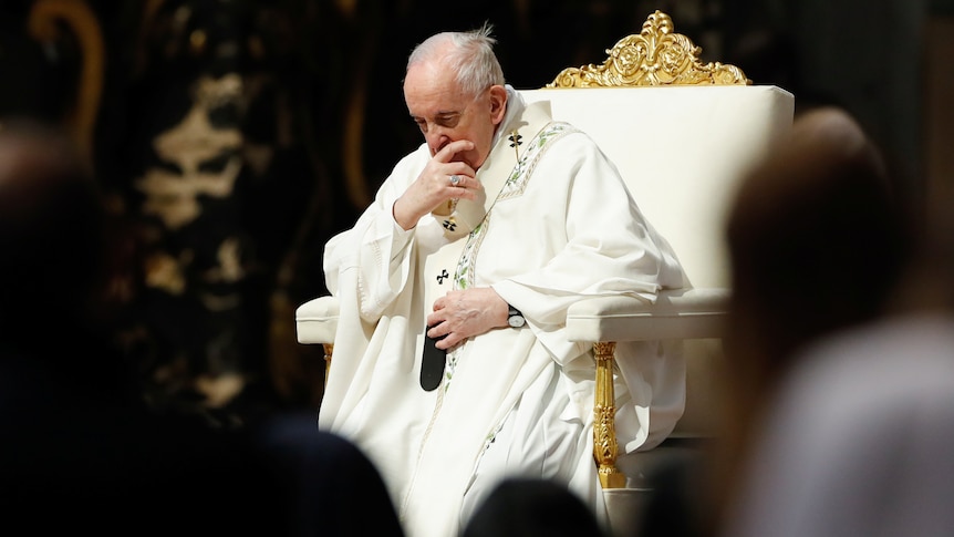 Pope Francis seated at The Vatican, head bowed and pensive