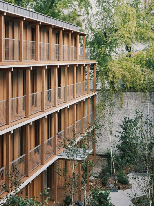 Timber apartments surrounded by greenery 