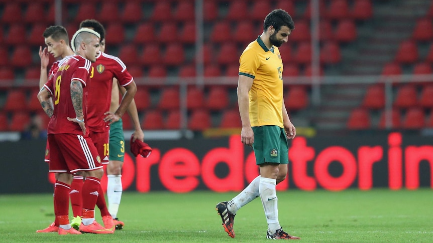 Australian captain Mile Jedinak looks dejected after Socceroos' loss to Belgium in September 2014.