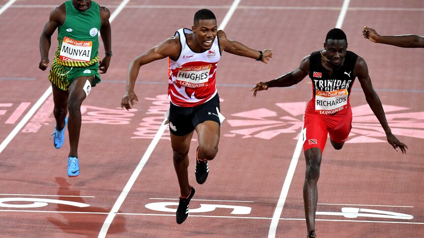 Zharnel Hughes of England (centre) and Jareem Ruichards of Trinidad and Tobago (right) during the Men's 200m Final.