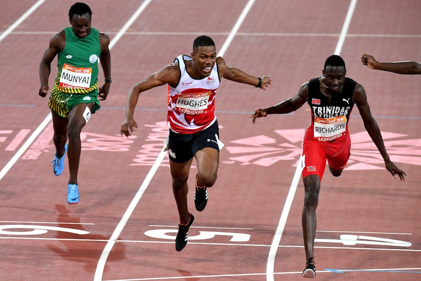 Zharnel Hughes of England (centre) and Jareem Ruichards of Trinidad and Tobago (right) during the Men's 200m Final.
