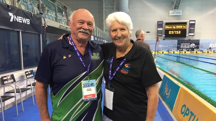 Former Olympic swimmers Peter Tonkin and Dawn Fraser by a pool