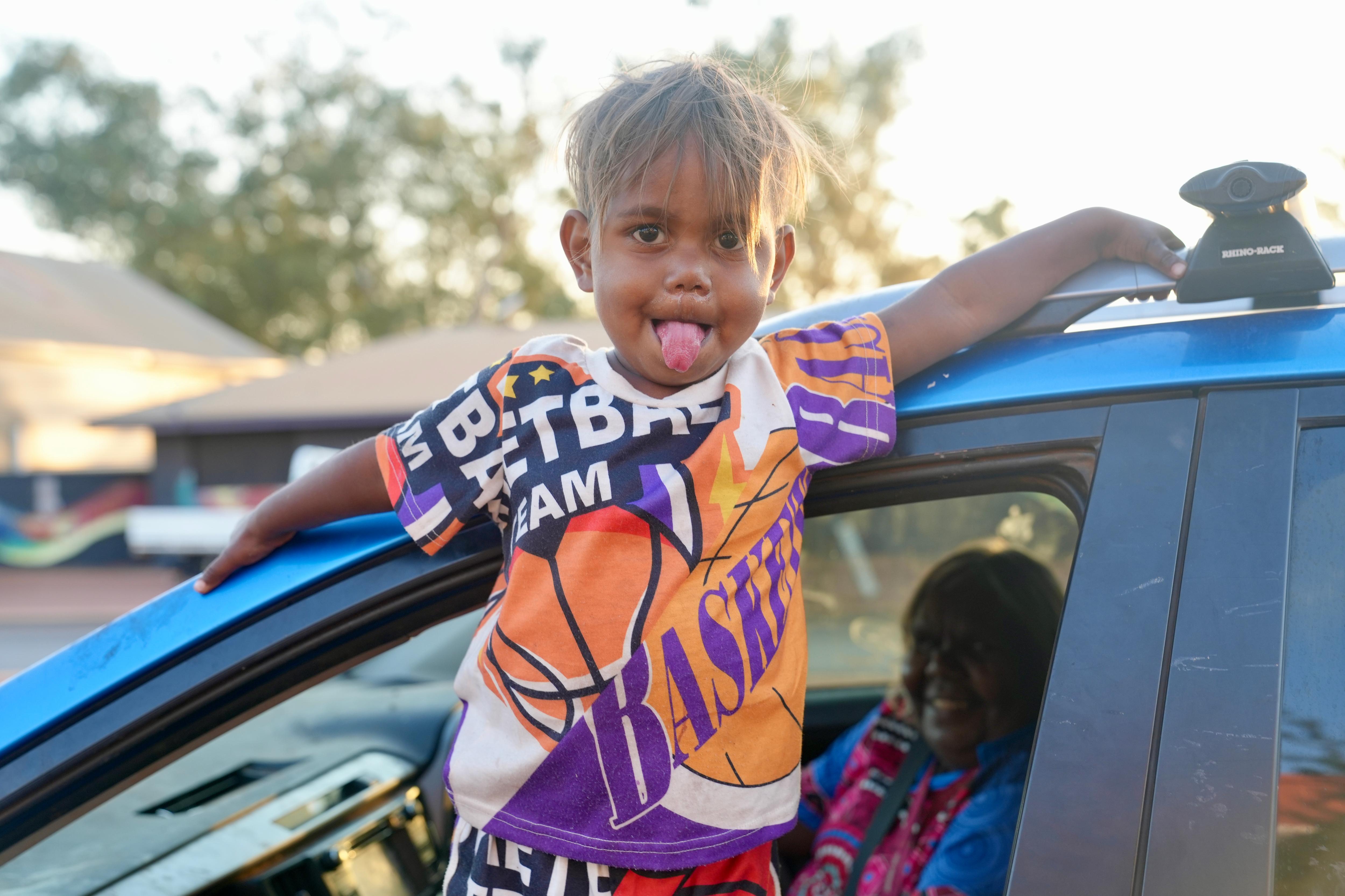 Indigenous kid poking his tongue out.