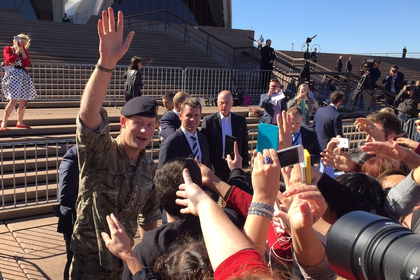 Prince Harry waves to the big crowd that gathered at Sydney Opera House