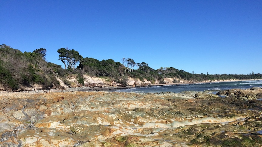 Rocks dominate the coastline at Byron Bay's Clarkes Beach after severe erosion