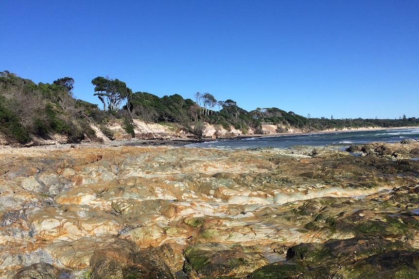 Rocks dominate the coastline at Byron Bay's Clarkes Beach after severe erosion