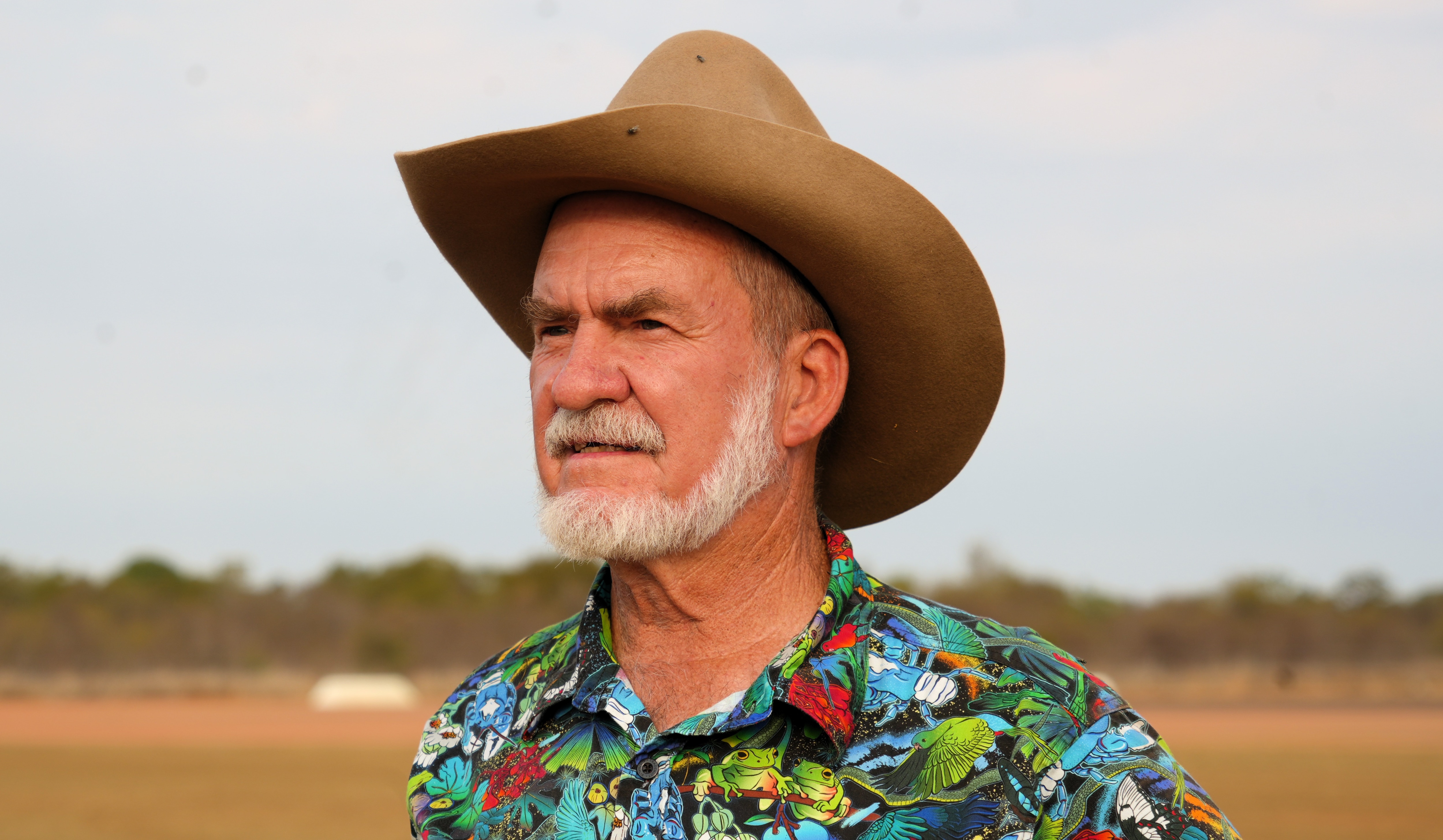 burke shire mayor ernie camp wearing colourful button up shirt, akubra style hat staring directly at camera not smiling