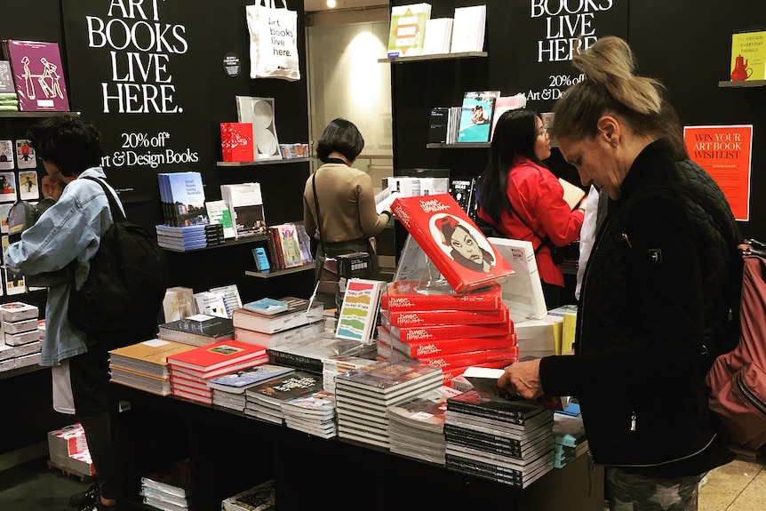 Women browse books in the Kinokuniya bookstore