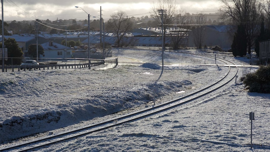 Snow on Orange railway tracks