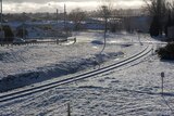 Snow on Orange railway tracks
