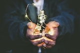Man holding lightbulb in his hand