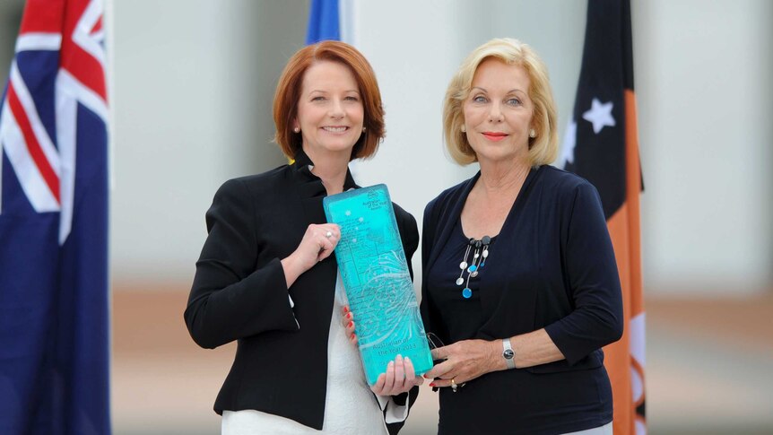 Prime Minister Julia Gillard presents Ita Buttrose with her 2013 Australian of the Year award.