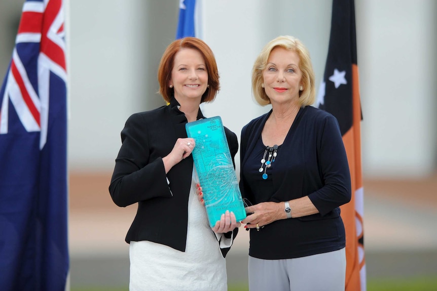 Prime Minister Julia Gillard presents Ita Buttrose with her 2013 Australian of the Year award.