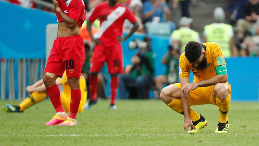 Socceroos skipper Mile Jedinak on his haunches after loss