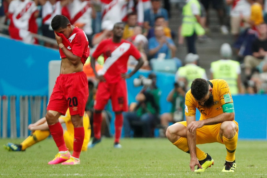 Socceroos skipper Mile Jedinak on his haunches after loss