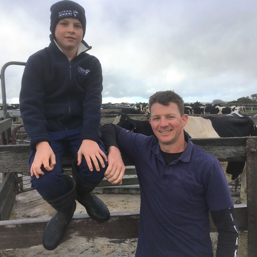 Zac and Jason McRae sitting on yards of milking shed.