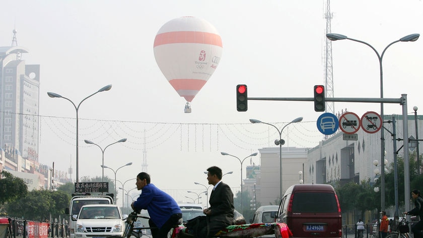 A pedi-cab makes its way down a Beijing street